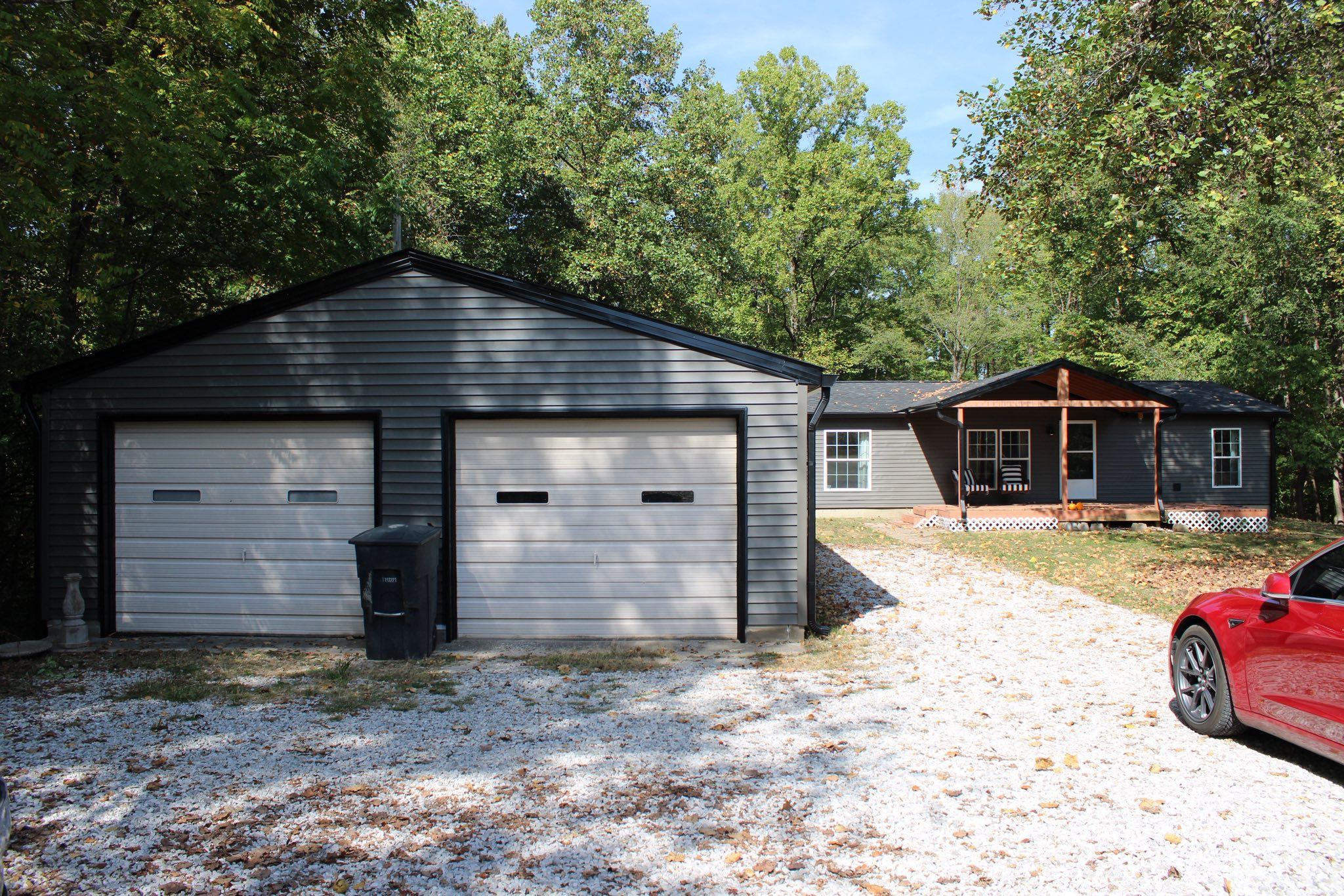 Completed ranch home and gray garage roof replacement