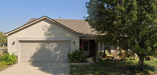 Gray siding home before roof replacement