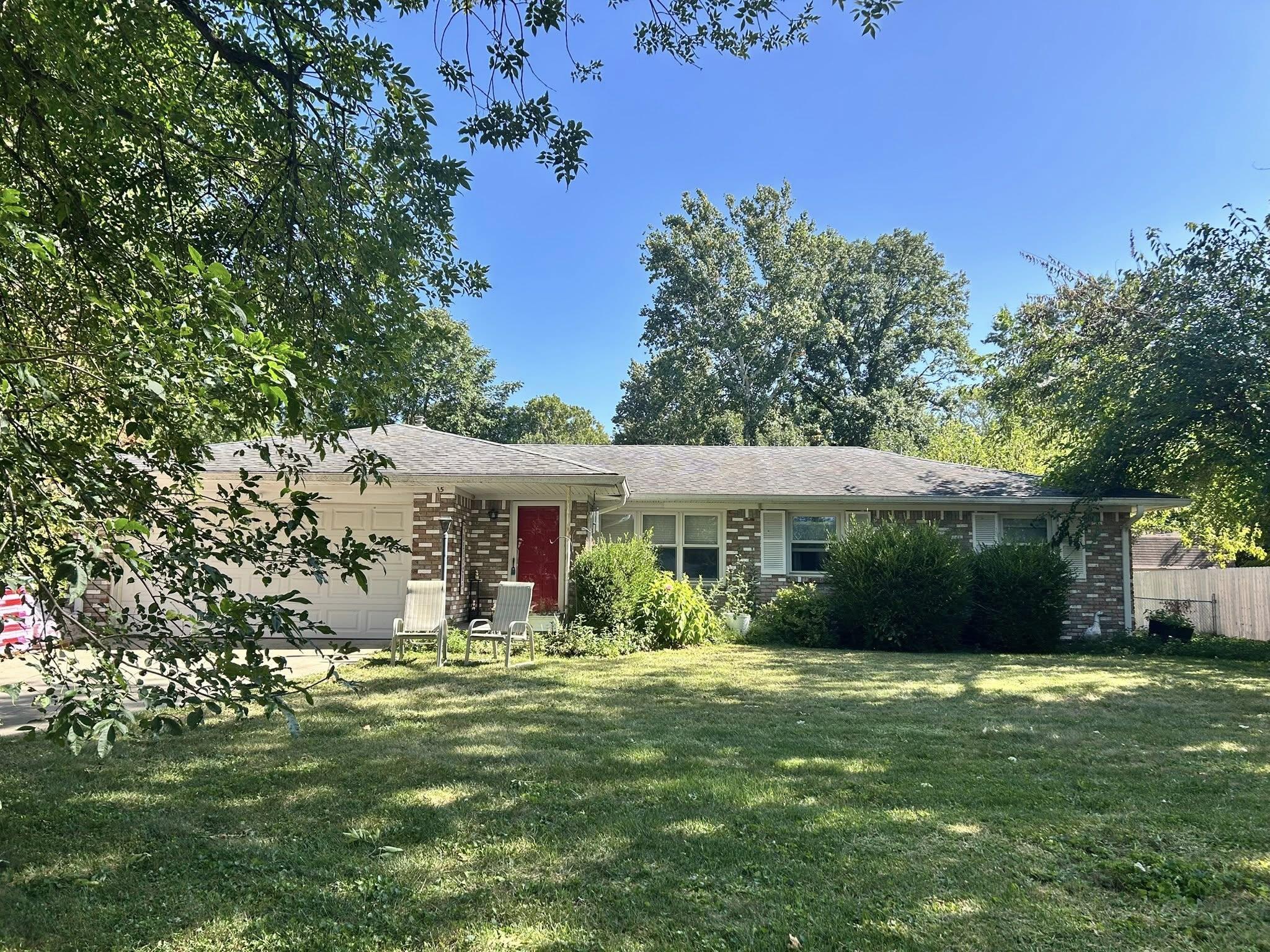 Stone accent ranch home before roof replacement